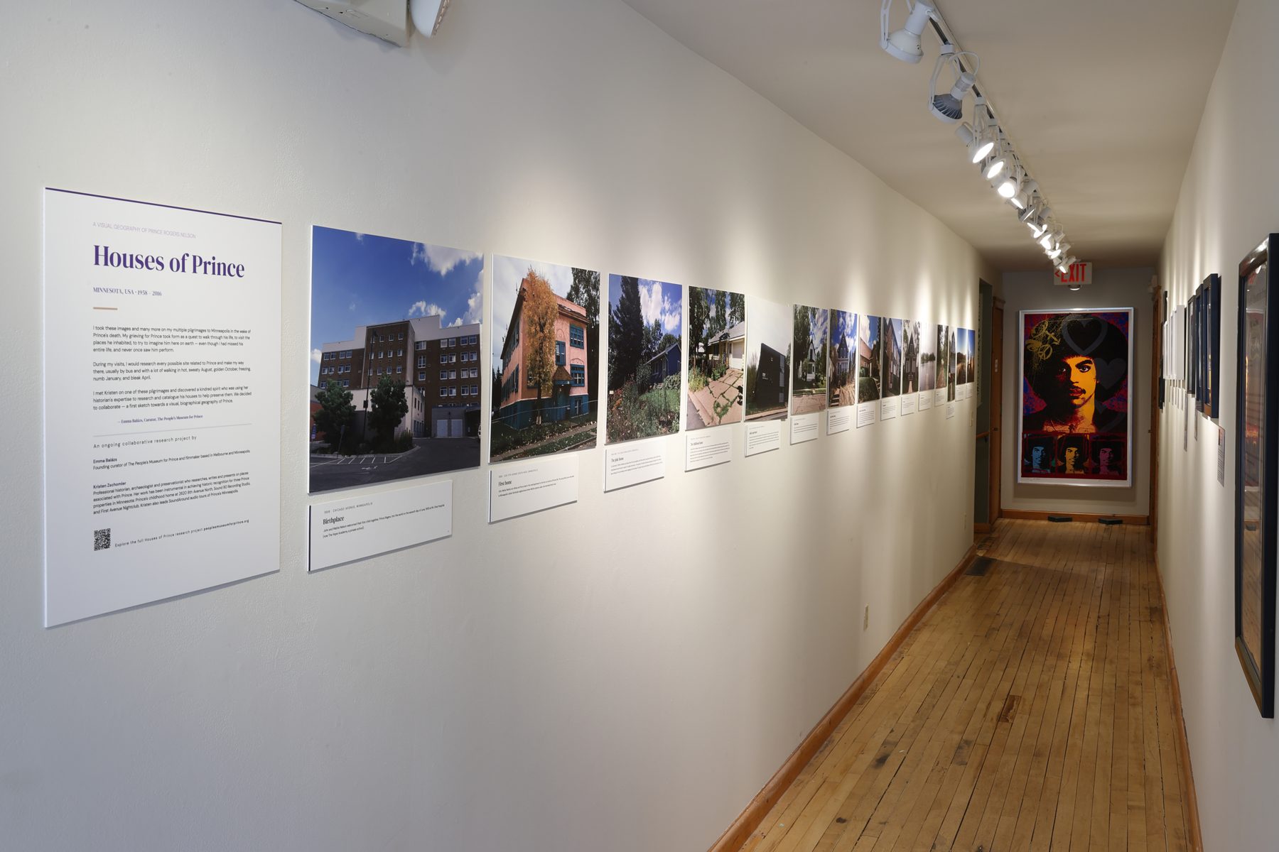 Houses of Prince: a corridor of photographs of houses with wall text